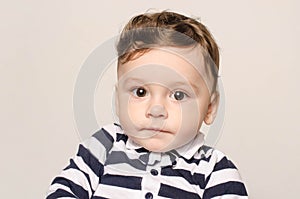 Portrait of a cute baby boy looking at camera with his big eyes.