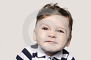 Portrait of a cute baby boy looking up making cute faces.