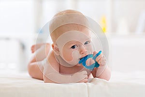 Portrait of a cute baby boy playing with teething toy