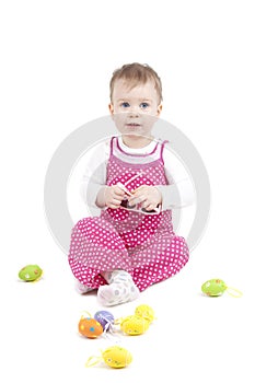 Portrait of a cute baby with Easter eggs