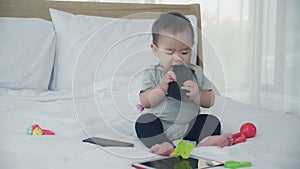 Portrait of cute baby girl sitting on bed at bedroom, happy of toddler is positive, newborn expression with cheerful 0-11 months.