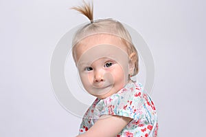 Portrait of a cute baby girl smiling at the camera.