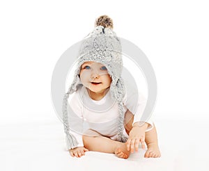 Portrait cute baby in grey knitted hat on white