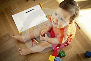 Portrait of a cute baby plaing on the floor