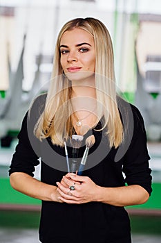 Portrait of a cute beautiful girl mekeup artist natural with long hair blond. In the studio, anti gravity fitness yoga .