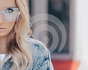 Portrait of cute blonde woman in blue sunglasses in outdoor