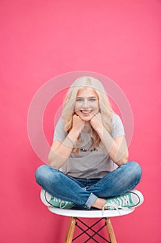 Portrait of a cute blonde woman sitting on the chair