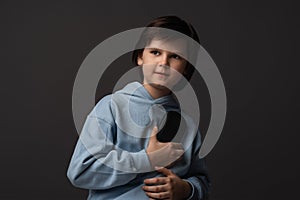 Portrait of Cute boy 10-12 years old with gamepad in hands playing video game. Childhood, facial expression concept