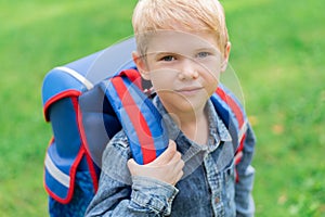 Portrait of cute boy with backpack. School. First grader