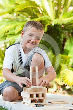 Portrait of cute boy playing with wooden blocks.