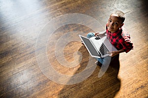Portrait of cute boy using laptop