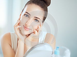 Portrait of a cute brunette woman touching her cheeks