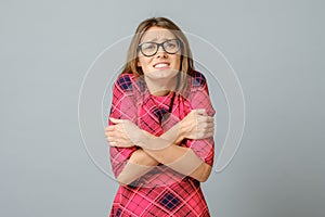 Portrait of cute caucasian girl trembling and feeling cold