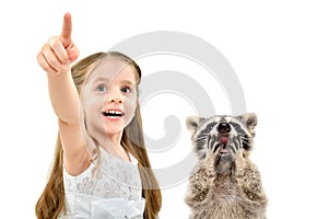 Portrait of cute cheerful girl pointing finger up and a surprised raccoon