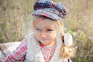 Portrait of a cute cheerful little girl on a nature.