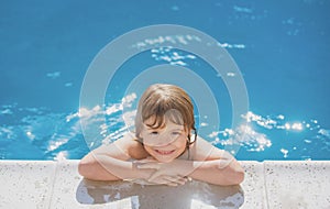 Portrait of a cute child boy. Caucasian kids face. Funny kid in swimming pool. Kids summer activities.