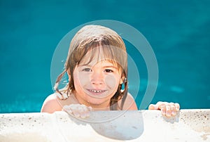 Portrait of a cute child boy in swimming pool. Close up caucasian kids face. Closeup head of funny kid. Kid relax in
