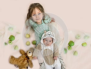 Portrait of cute children. Baby and older sister. Education of children of different ages