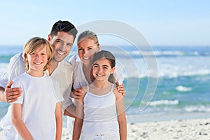 Portrait of a cute family at the beach