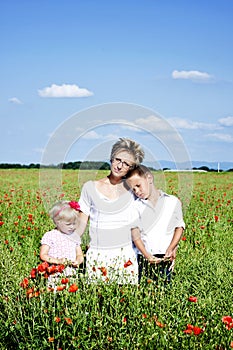 Portrait of cute family in poppy field