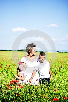 Portrait of cute family in poppy field