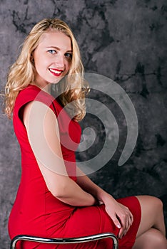 Portrait of a cute fashionable woman in a red tight dress