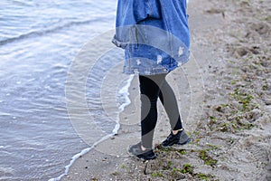 Portrait of cute female who breathes fresh sea air and poses wit