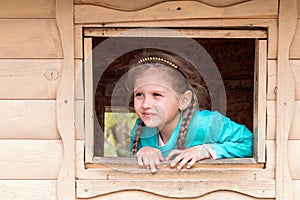 portrait of a cute five-year-old cheerful girl with pigtails