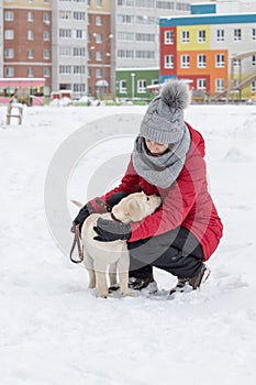 Portrait with cute fluffy puppy. Winter walk with dog. young woman walks with puppy, snowy winter