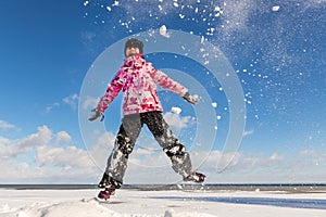 Portrait of cute funny adorable little playful child girl wearing warm snow jacket enjoy having fun playing at park