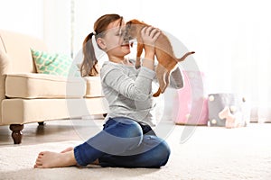 Portrait of cute girl with funny Brussels Griffon dog at home. Loyal friends