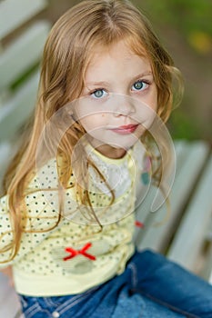 Portrait of a cute girl with long blond hair