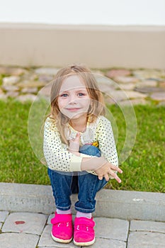 Portrait of a cute girl with long blond hair