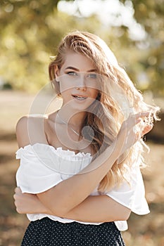 Portrait of a cute girl outdoors in a summer park