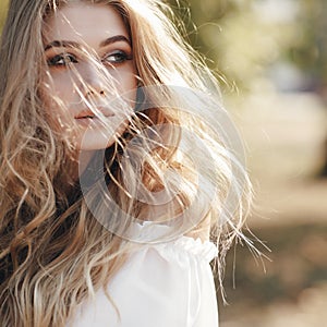 Portrait of a cute girl outdoors in a summer park