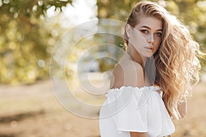 Portrait of a cute girl outdoors in a summer park