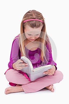 Portrait of a cute girl reading a book