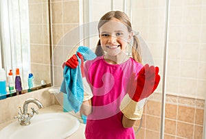 Portrait of cute girl in rubber gloves doing cleanup at bathroom