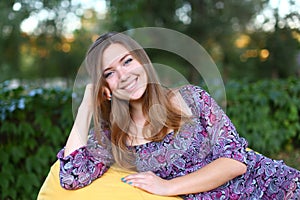 Portrait of cute girl sitting in chair and smiling in photograph