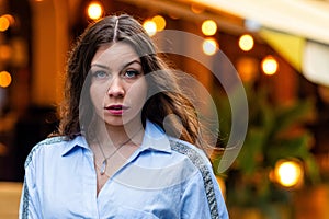 portrait of a cute and gorgeous women posing on blurred strret background with bokeh light