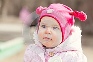 Portrait cute happy baby girl in hat in summer park,