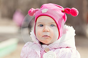 Portrait cute happy baby girl in hat in summer park,