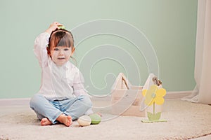 Portrait of cute happy baby girl playing with easter decorations