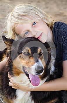 Portrait of a cute happy child hugging his pet dog photo