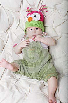 Portrait of cute happy 5 month old baby boy with funny hat.