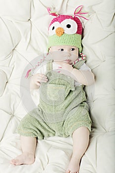 Portrait of cute happy 5 month old baby boy with funny hat.