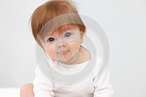 Portrait of cute happy six month baby girl. Childhood and baby care concept