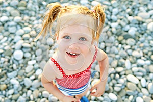 Portrait of cute happy smiling little girl on the seaside