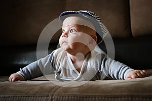 Portrait of cute infant boy lying on couch. Cute 4 month old baby. Infancy, babyhood concept.