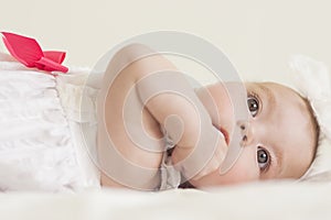 Portrait of Cute Infant Caucasian Female Child. Against White